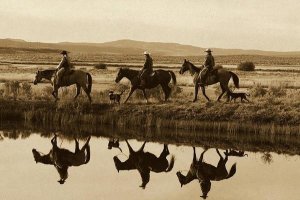 Konrad Wothe - Cowboys and a cowgirl riding Horses beside pond, Oregon - Sepia
