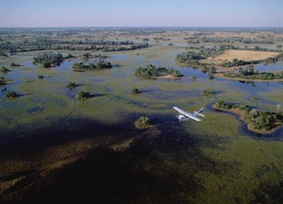 Konrad Wothe - Safari airplane flying over the flooded Okavango Delta, Botswana