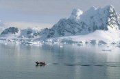 Konrad Wothe - Tourists in zodiac boat with snow covered landscape, Paradise Bay, Antarctica