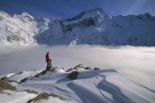 Colin Monteath - Mt Sefton, climber above cloud-filled Mueller Glacier, Mt Cook NP, New Zealand