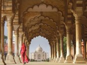 Pangea Images - Woman in traditional Sari walking towards Taj Mahal