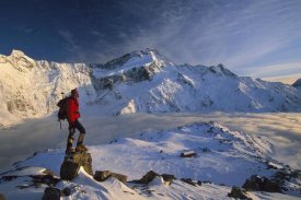 Colin Monteath - Mt Sefton, climber at dawn above Mueller hut and cloud-filled Mueller Glacier, Mt Cook National Park, New Zealand