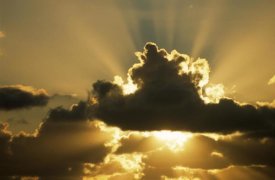 Aad Schenk - Sun rays beam from behind cumulus clouds