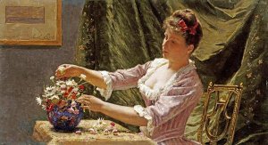 Emile Claus - A Young Woman Arranging Flowers