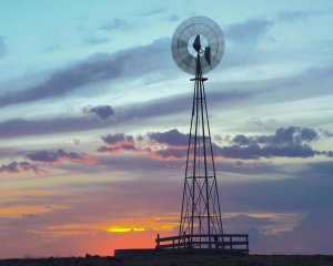 Tim Fitzharris - Windmill producing electricity at sunset example of renewable energy, North America