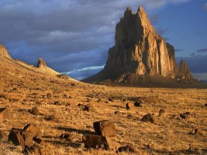 Tim Fitzharris - Shiprock, the basalt core of an extinct volcano, tuff-breccia ejected boulders in foreground, New Mexico