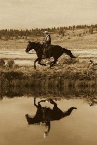 Konrad Wothe - Cowboy riding Horse beside pond with two dogs, Oregon - Sepia