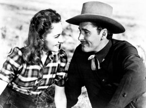 Hollywood Photo Archive - Errol Flynn with Ann Sherdian in Dodge City