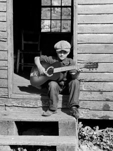 Arthur Rothstein - Corbin Hollow, Shenandoah National Park area. The son of a squatter seated in a doorway, 1935