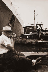 Angelo Rizzuto - A cigarette break at the docks near the Queen Elizabeth and Carol Moran, New York City, 1959