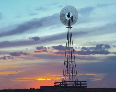 Tim Fitzharris - Windmill producing electricity at sunset example of renewable energy, North America