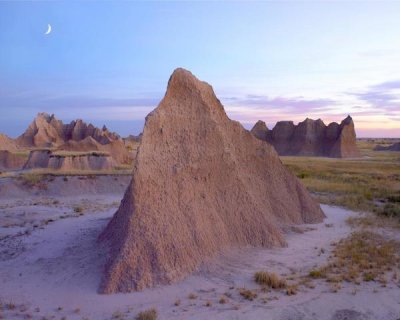 Tim Fitzharris - Crescent moon over landscape showing erosional features, Badlands National Park, South Dakota