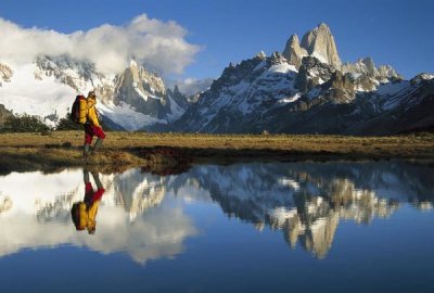 Colin Monteath - Hiker, Cerro Torre and Fitzroy reflected in small pond at dawn, Loma Plieque Tumbado, Los Glaciares National Park, Patagonia, Argentina