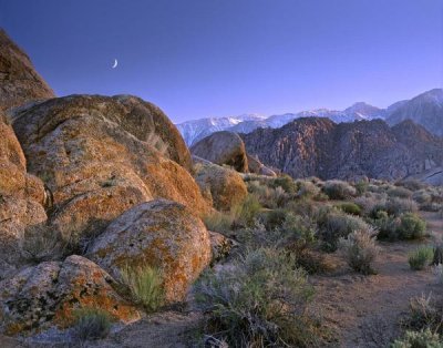 Tim Fitzharris - Crescent moon rising over Sierra Nevada seen from Alabama Hills, California