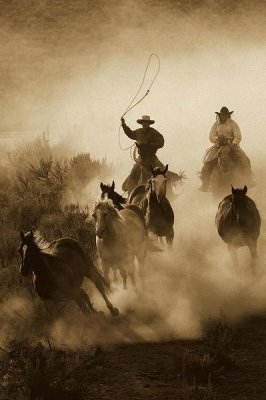 Konrad Wothe - Horses herded by cowboy and cowgirl, Oregon - Sepia