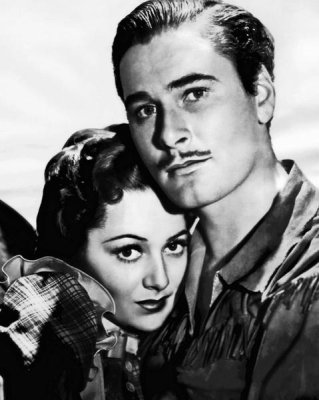 Hollywood Photo Archive - Errol Flynn with Ann Sherdian in Dodge City