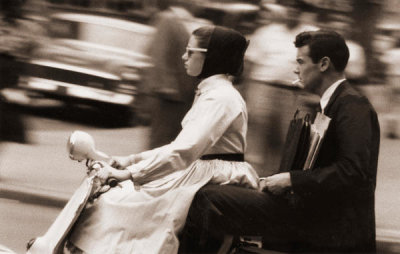 Angelo Rizzuto - Woman and man on motorized scooter, New York City, 1957